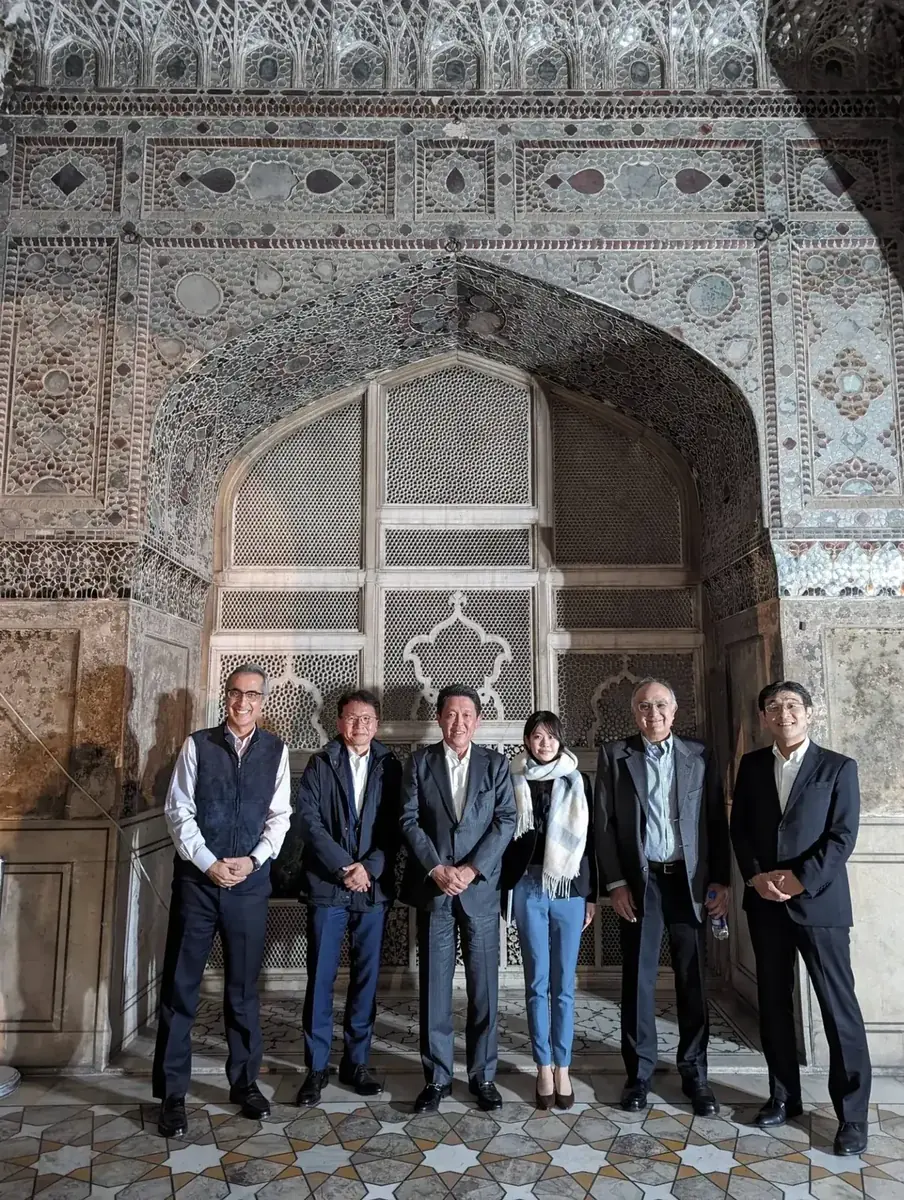 International visitors photographing historic interiors at Lahore Fort