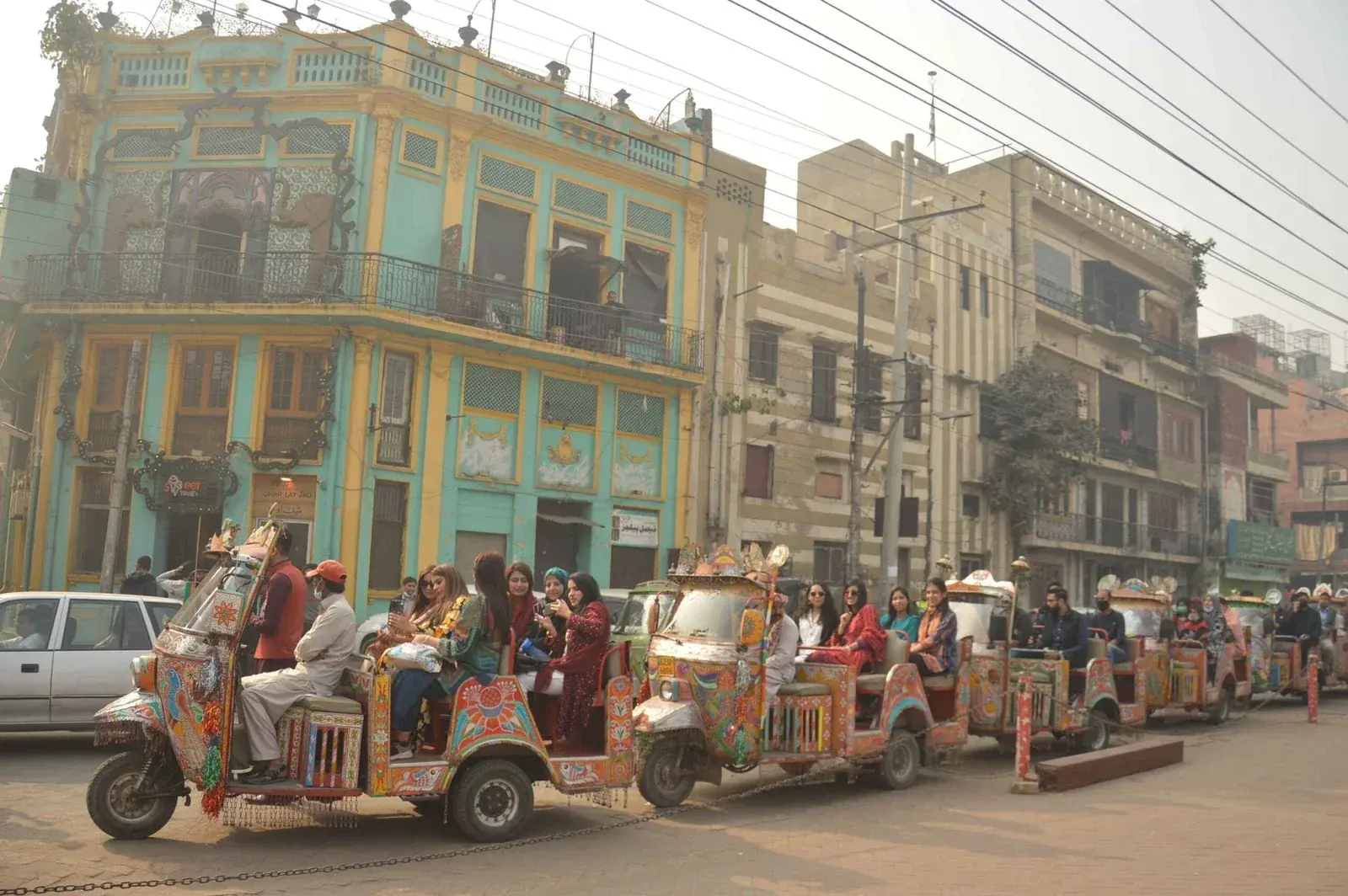 Decorated Rangeela rickshaws carrying visitors through Lahore