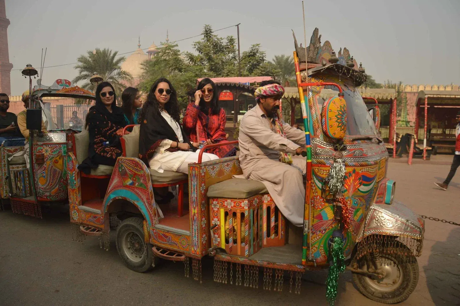 Guests riding a decorated rickshaw on a Lahore like-a-local tour