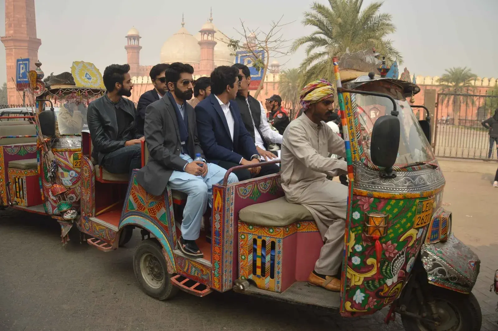 Private guests touring Lahore by decorated rickshaw