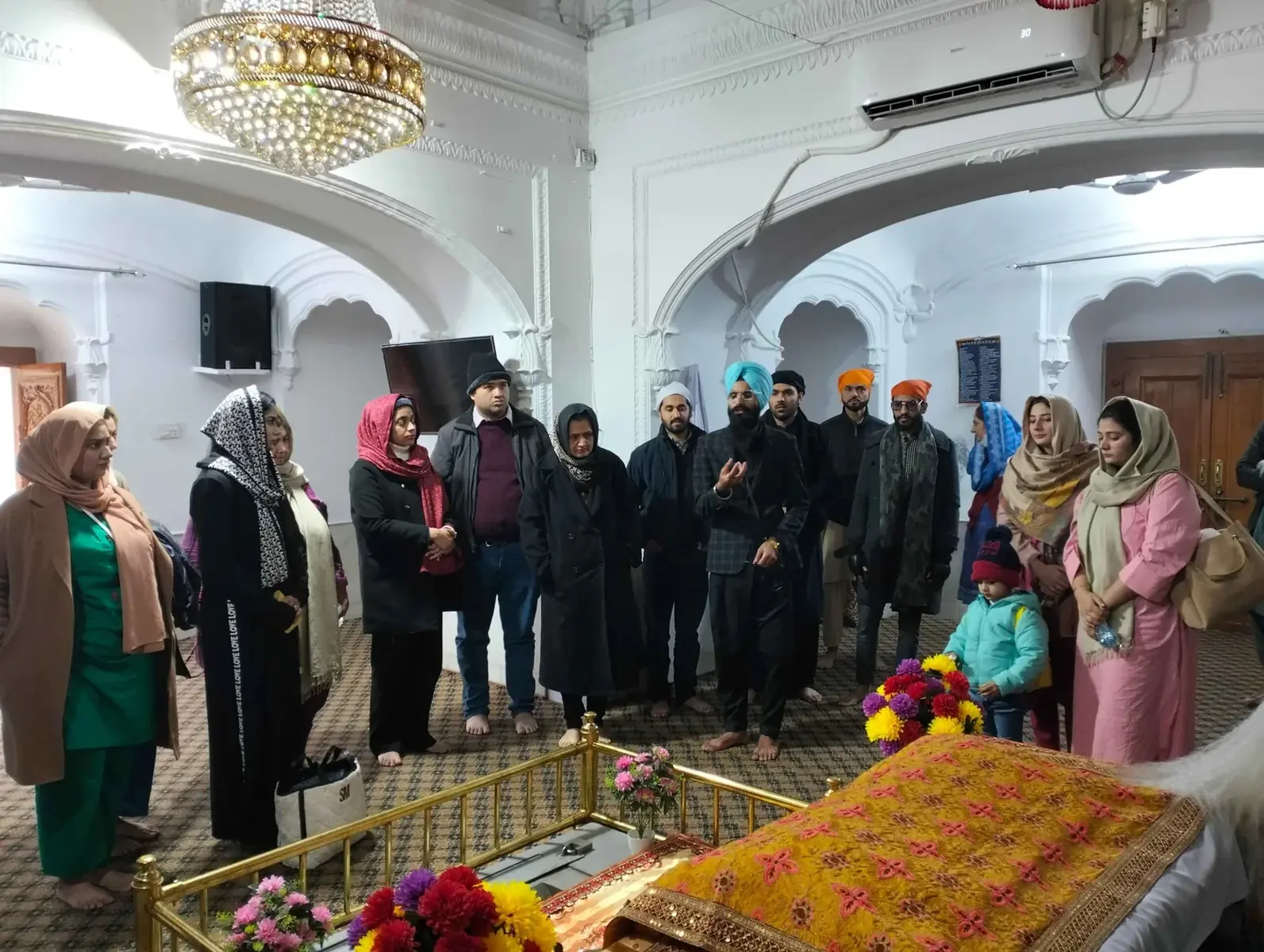 Visitors listening to a guide during a Sikh heritage visit in Lahore